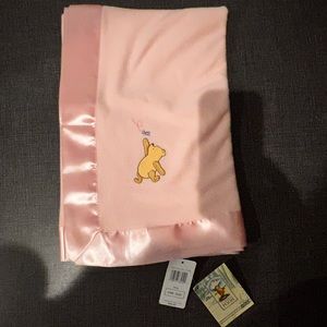 New Classic Winnie the Pooh pink baby’s blanket. Never used and tags on it.